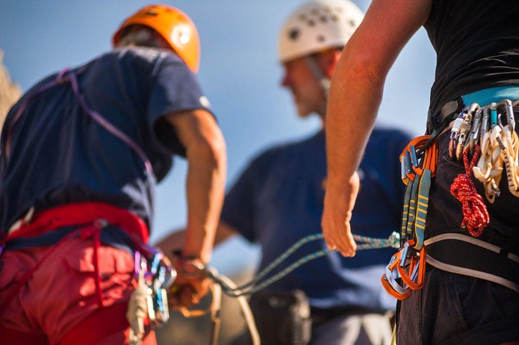 Rock climbers prepping harnesses