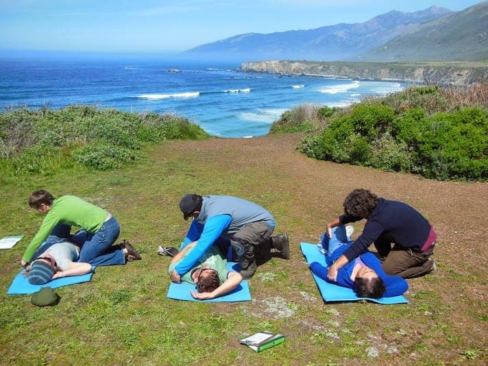 Students performing first aid outdoors