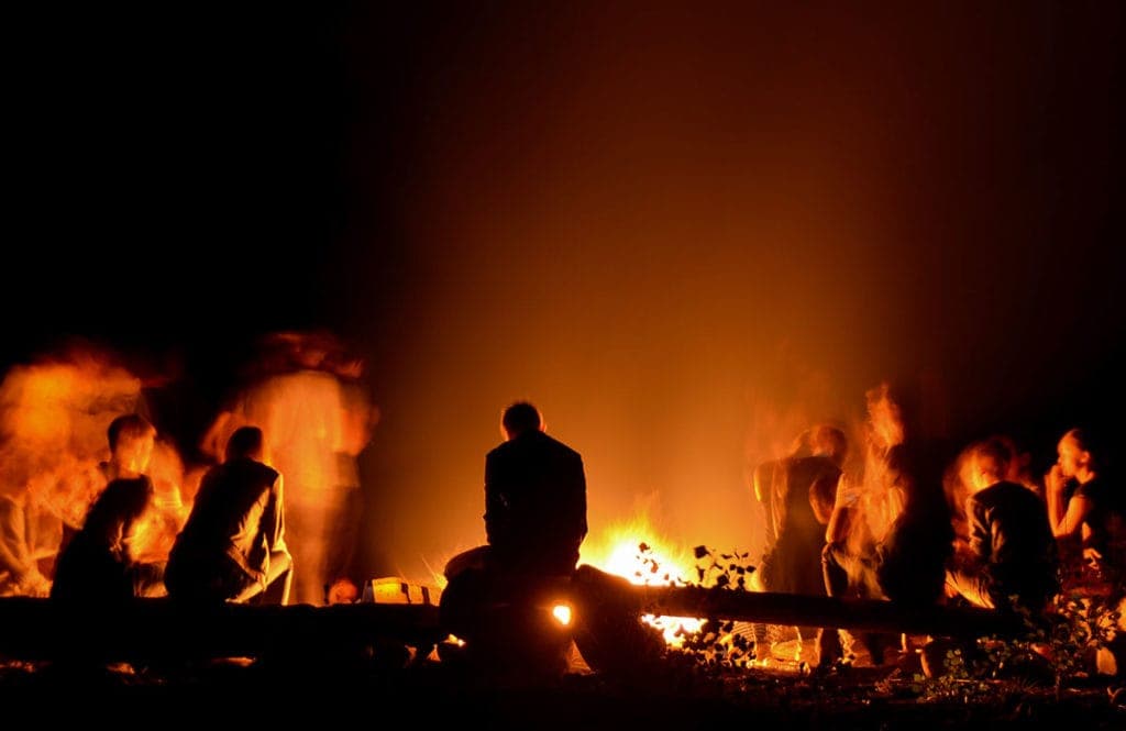 Campers sitting around campfire